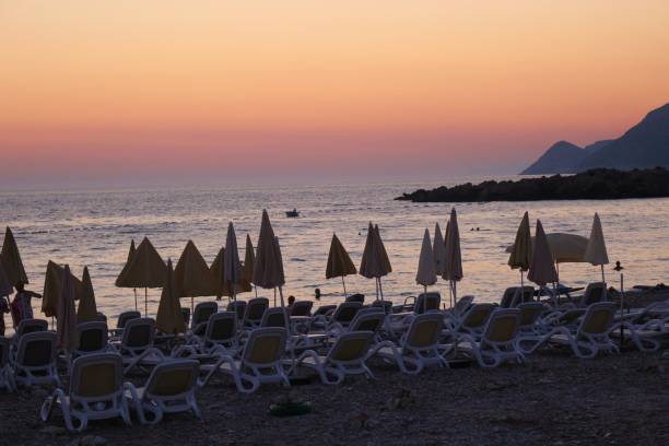 ビーチのドブラー voda のモンテネグロは、夕日の光の中。 - bar chairs ストックフォトと画像