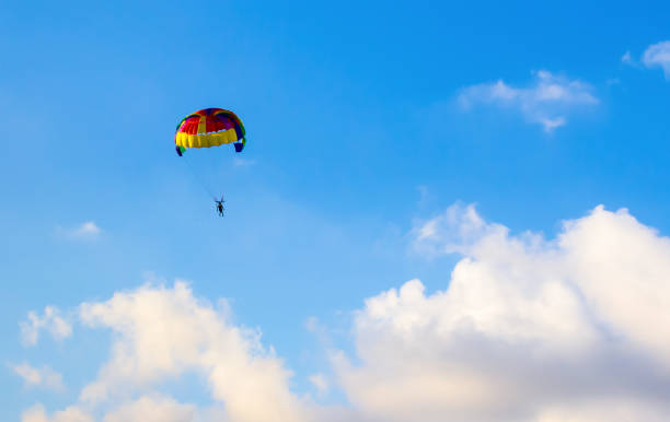 istock skydiver high in the blue sky white clouds extreme vacation entertainment 950372196