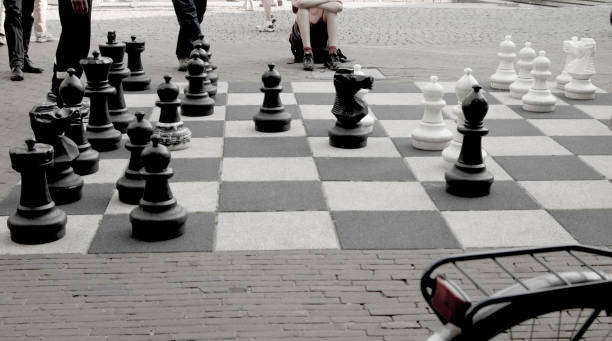 istock Chess Match Being Played on a Cobblestone Street 950375724