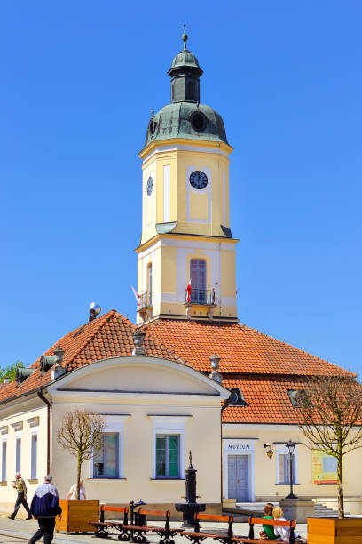 Bialystok, Poland - April 30, 2012: Town hall tower over red tile roof on central square of Kosciusko Market in Bialystok, Poland. Museum of Podlasie in Baroque style, 1745-1761, architect Ian Klemm