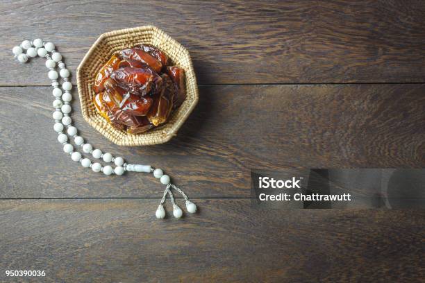 Table Top View Aerial Image Of Decoration Ramadan Kareem Holiday Backgroundflat Lay Date In Wood Basket With White Prayer Beads On Modern Rustic Brown Wood At Office Deskfree Space Creative Design Text Stock Photo - Download Image Now