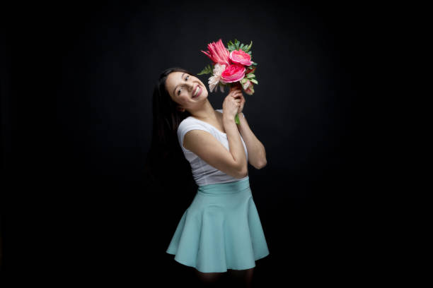 istock Cute young lady holding flowers 950393260