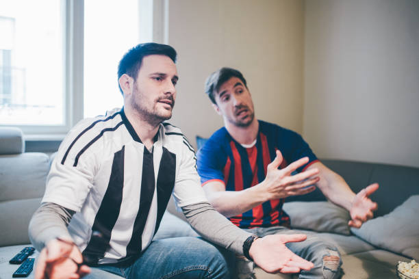 istock Annoyed friends watching soccer game 950398306