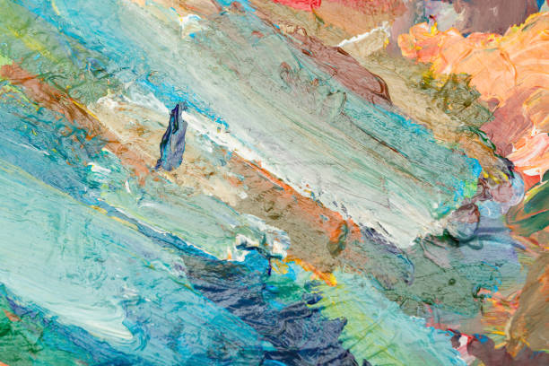 Artist palette with mixed oil paints. Abstract background with colorful brush strokes on a canvas. Multi-color paint background