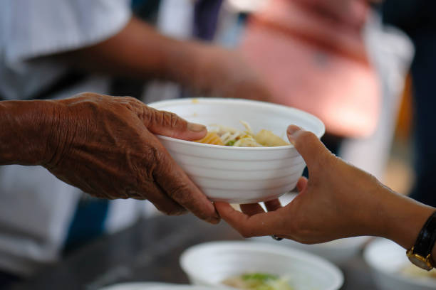 istock poverty concept feeding food for beggar 950409392