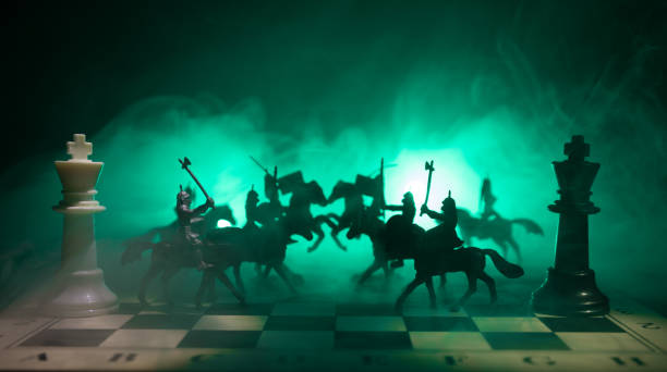 istock Medieval battle scene with cavalry and infantry on chessboard. Chess board game concept of business ideas and competition and strategy ideas Chess figures on a dark background. Selective focus 950409632