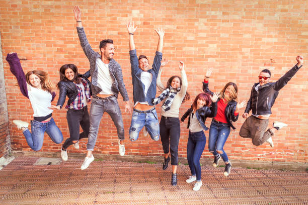 istock large group of friends jumping together 950416382