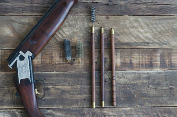 istock Shotgun guns overlaid with cleaning utensils and writing space. 950424866