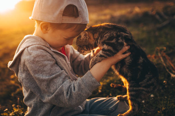 Little girl kissing her cat in monochrome.