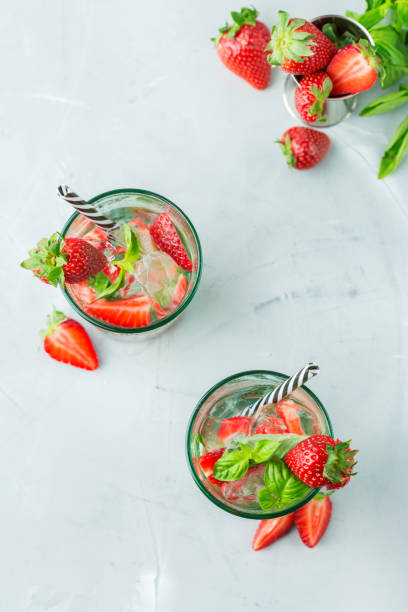 istock Alcohol cocktail mojito lemonade with rum, soda, strawberry and basil 950428634