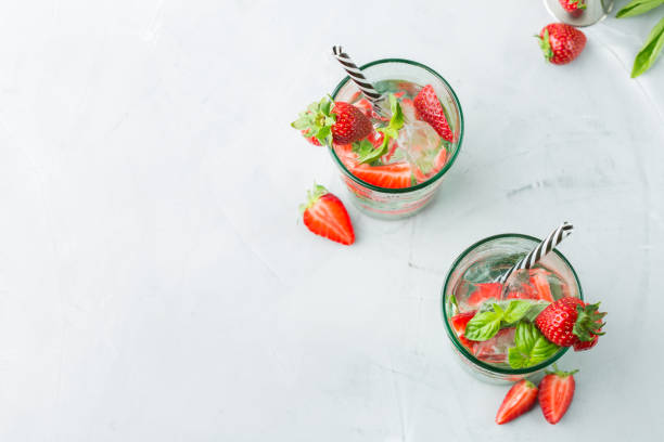 Alcohol cocktail mojito lemonade with rum, soda, strawberry and basil