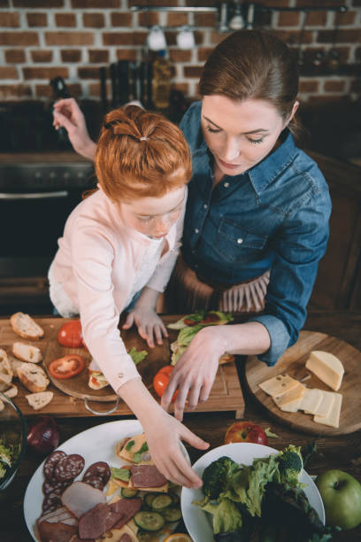 istock daughter and mother making salad 950428968