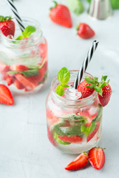istock Alcohol cocktail mojito lemonade with rum, soda, strawberry and basil 950430470