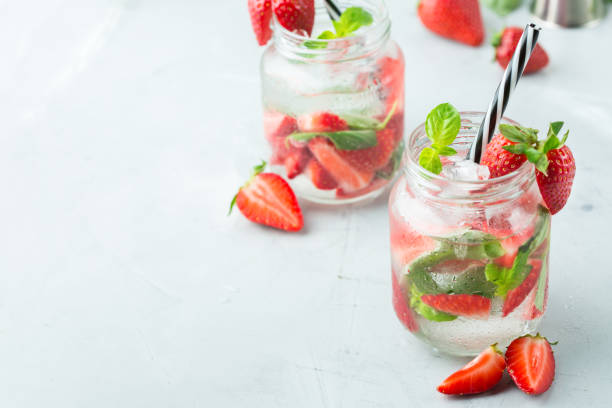 istock Alcohol cocktail mojito lemonade with rum, soda, strawberry and basil 950430538