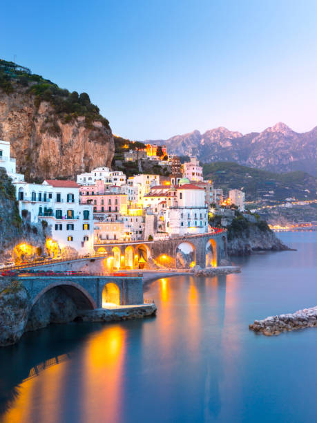 Night view of Amalfi on coast line of mediterranean sea, Italy Night view of Amalfi cityscape on coast line of mediterranean sea, Italy portofino stock pictures, royalty-free photos & images