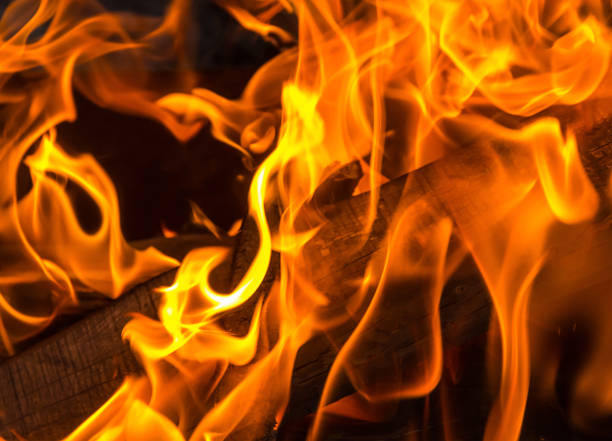 istock orange flame bright background. burning fuel for the fire board close-up 950432814
