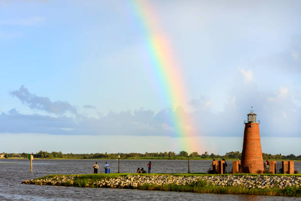 Just After the Storm a Rainbow Appeared Lake Tohopeliga in Kissimmee Florida has a unique Lighthouse at the northern shoreline - which is much enhanced by a brief afternoon shower offering this perfect Rainbow. kissimmee stock pictures, royalty-free photos & images