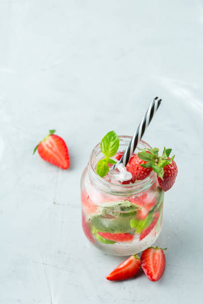 istock Alcohol cocktail mojito lemonade with rum, soda, strawberry and basil 950433204