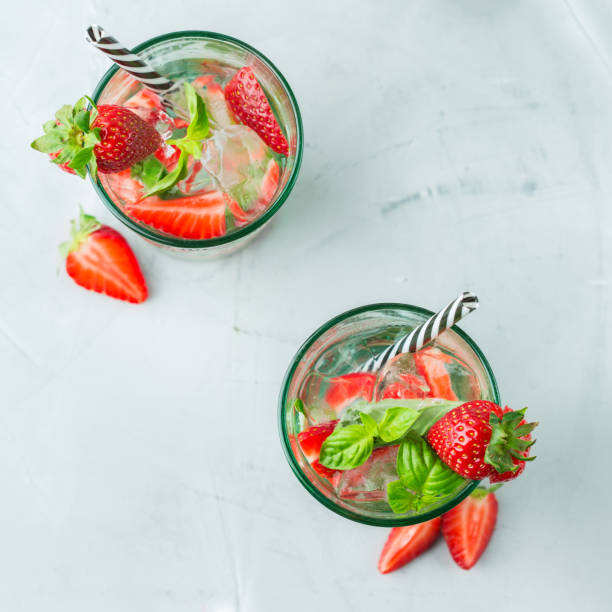 istock Alcohol cocktail mojito lemonade with rum, soda, strawberry and basil 950433304