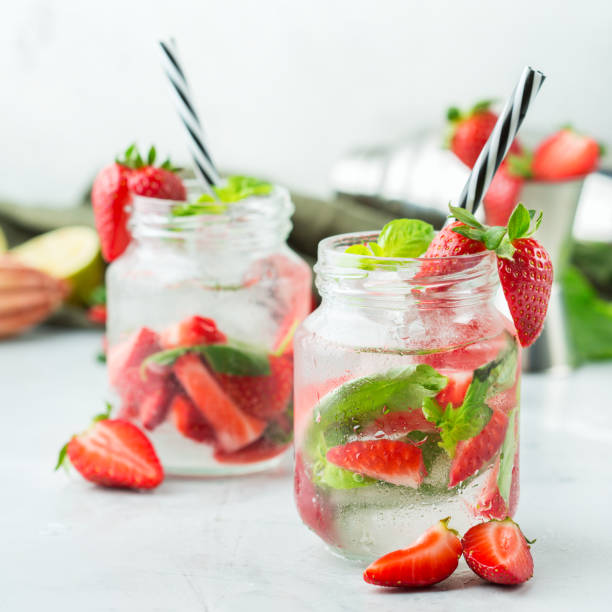 istock Alcohol cocktail mojito lemonade with rum, soda, strawberry and basil 950433370