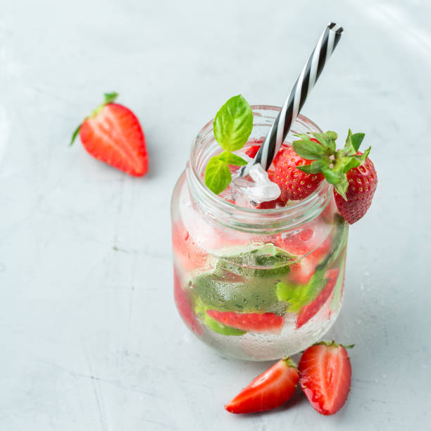 istock Alcohol cocktail mojito lemonade with rum, soda, strawberry and basil 950433532