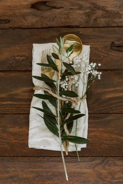 istock Flat lay Gold vintage silverware, linen napkin, olive brunch Trendy rustic table setting 950436742