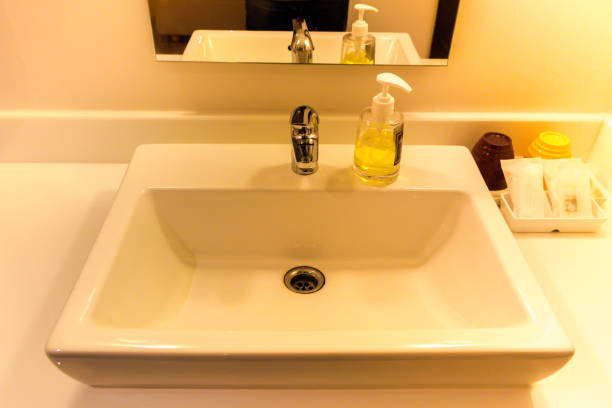 istock White Sink Basin with Stainless Steel faucet 950438754