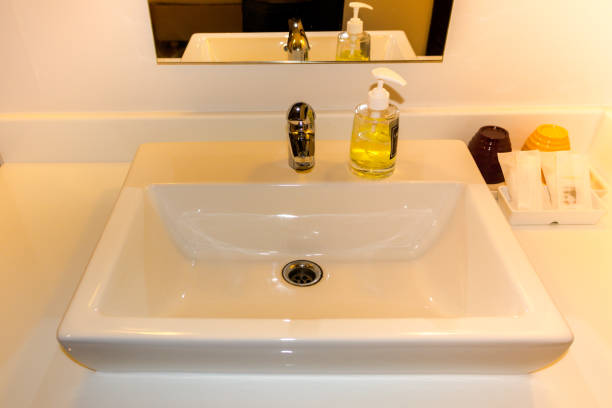 istock White Sink Basin with Stainless Steel faucet 950438802
