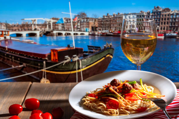 istock Pasta with a plate of sauce on the table in Amsterdam. 950441930