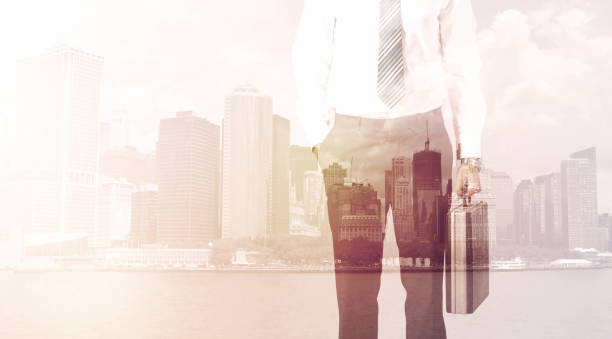 istock Businessman standing at cityscape background 950445602