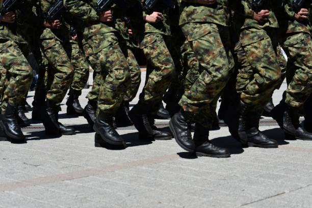 Army military soldiers marching in a parade outdoors. Army military soldiers marching in a parade outdoors. national guard stock pictures, royalty-free photos & images