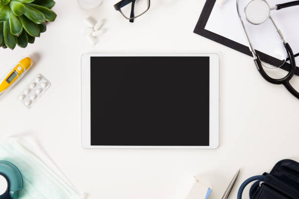 Flat Lay Of Digital Tablet And Medical Instruments On Table Flat lay of digital tablet and medical instruments by plant on white table tablet pc and digital hospital tools stock pictures, royalty-free photos & images