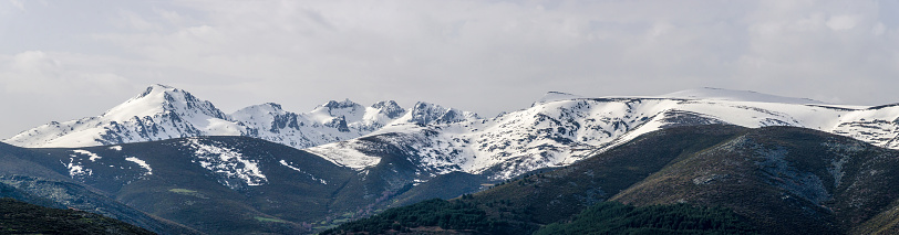 Panoramic view of snowy landscape with virgin snow untouched by the man in a mountain range and peaks in Sierra de Gredos, Avila, Spain