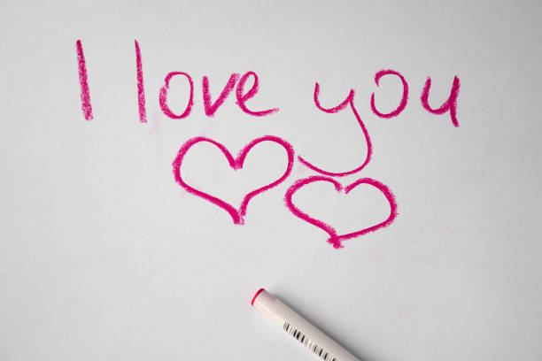 istock Text l love you hand written by colored pen on white paper 950459542