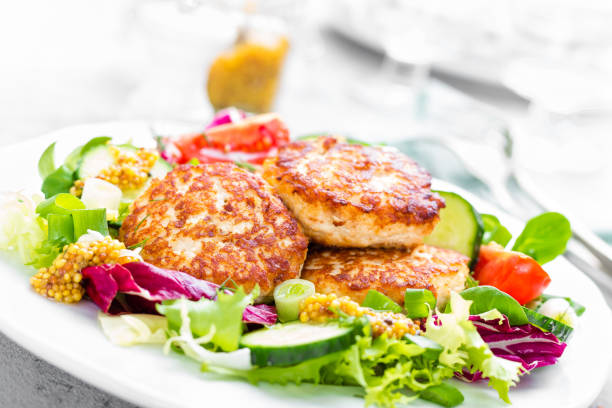 istock Cutlets and fresh vegetable salad on white plate. Fried meatballs with vegetable salad 950459868