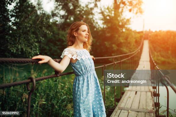 Young Beautiful Girl Standing On The Bridge Over The River Stock Photo - Download Image Now