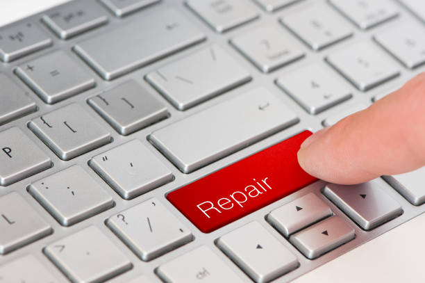 istock A finger press red Repair button on laptop keyboard 950460432