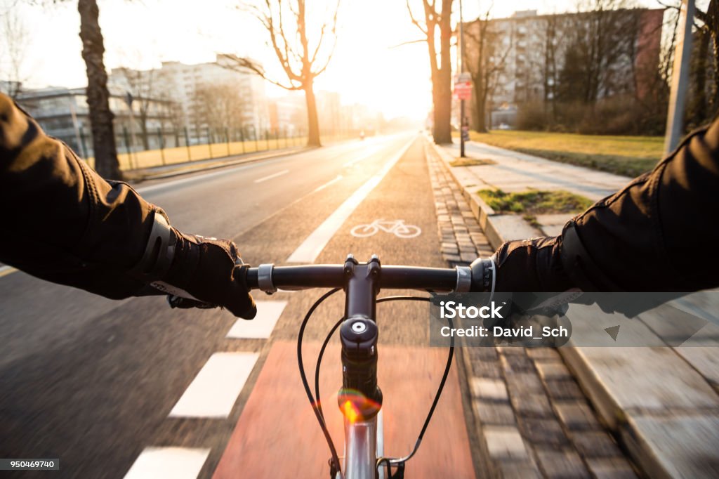 First-person view of cyclist in the city at morning Cycling Stock Photo