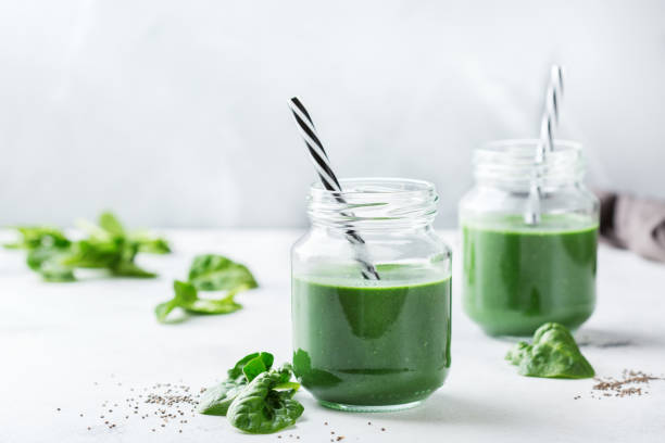 Healthy green vegan smoothie with spinach, spirulina and chia seeds Food and drink, dieting and nutrition concept. Healthy green vegan smoothie with spinach leaves, spirulina and chia seeds for detox in summer days detox stock pictures, royalty-free photos & images