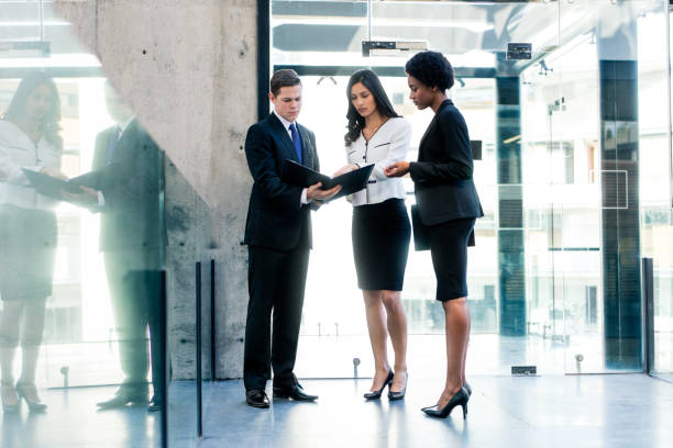 istock Multi-ethnic group of three standing and looking at file 950476888