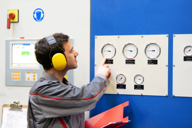 industrial workers inspect the technology of a plant for function - assembler in working clothes