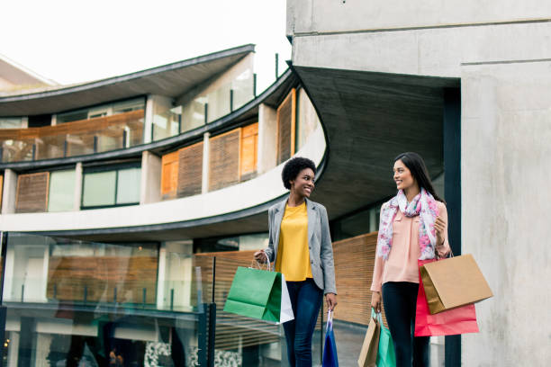 istock Multi-ethnic friends carrying shopping bags and smiling 950477614