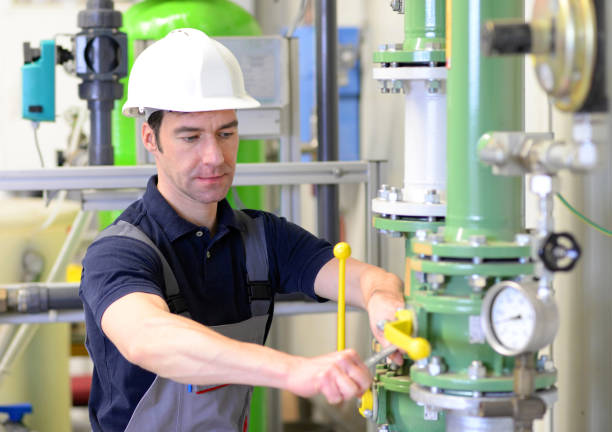 istock industrial worker repairs machines and equipment in a refinery 950477800