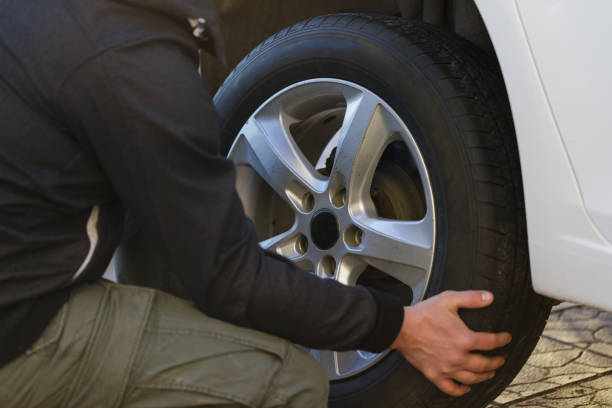 istock Man is changing a wheel in a car, close-up 950484806