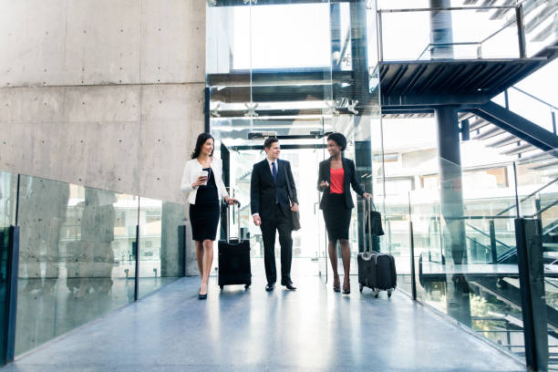 istock Business people on the move holding suitcases and smiling 950485754
