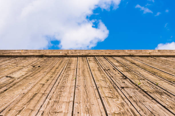 wooden roof and blue sky with clouds - copy space, background
