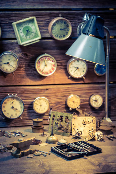 istock Watchmaker's workshop with clocks, spare parts and tools 950489686