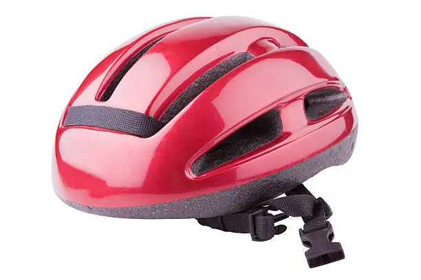 Photo of A shiny red bicycle helmet on a white background