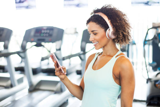 istock Woman Using Smart Phone at the Gym 950496120
