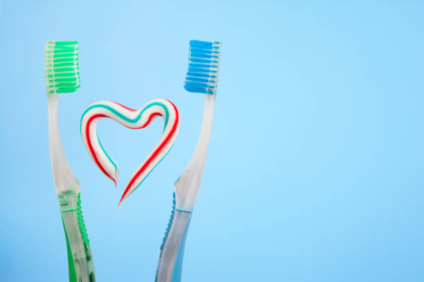 istock the heart symbol is made from a three-color toothpaste and is located between two toothbrushes 950499292